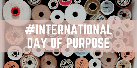 "#International Day Of Purpose" with an assortment of spools in the background