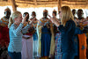 Jane Mosbacher Morris (founder & CEO) dancing with Cindy Jones-Nyland (CMO) and other Kenyan artisans