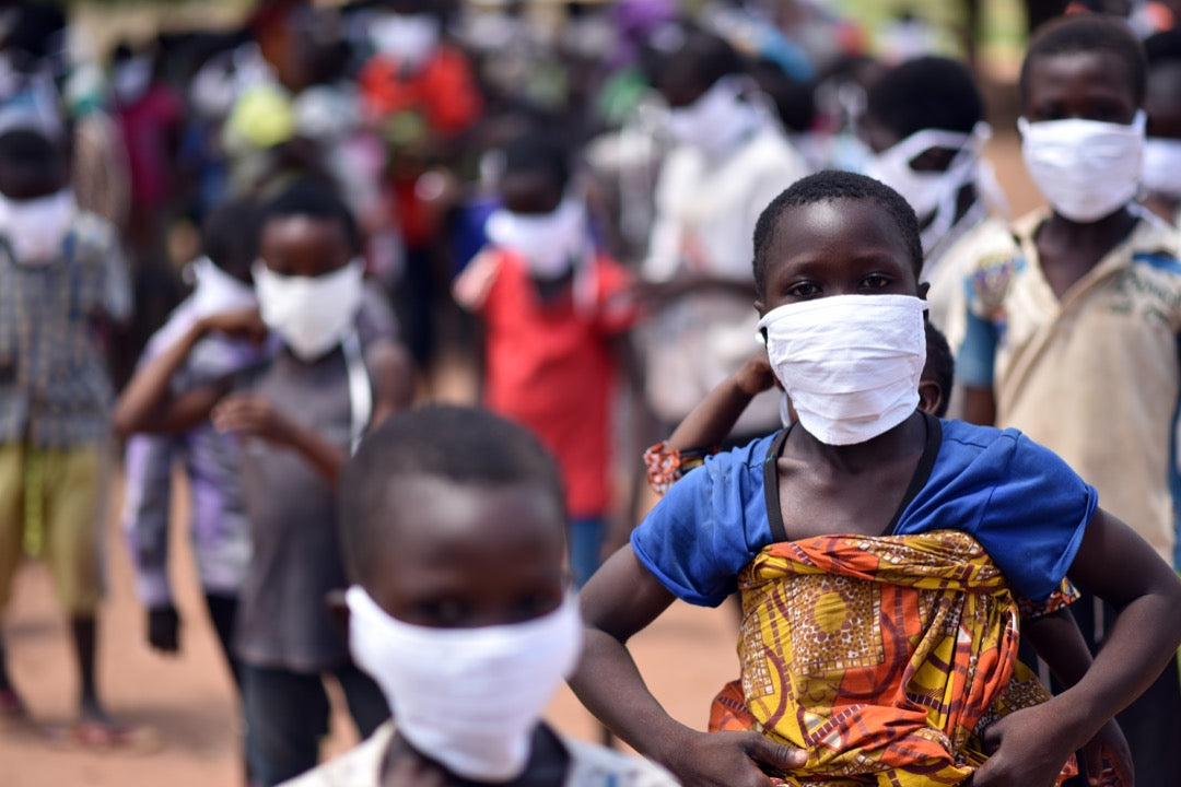 A photo of young boys wearing masks in West Africa